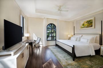 a room with a bed and a tv