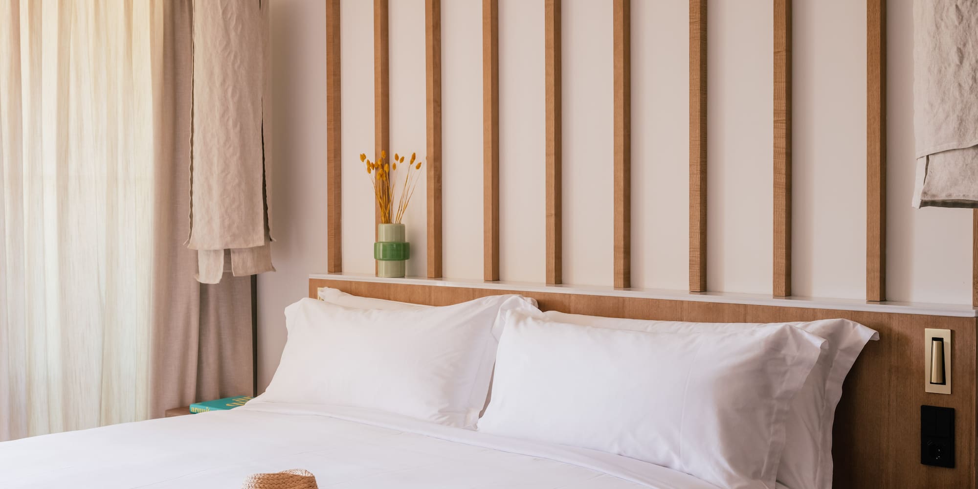 a bed with a hat on it