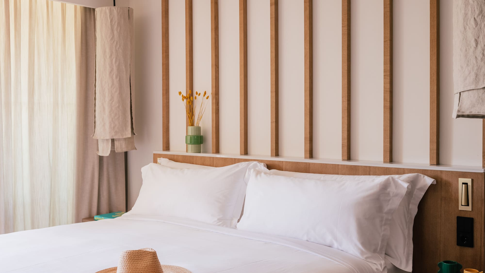 a bed with a hat on it