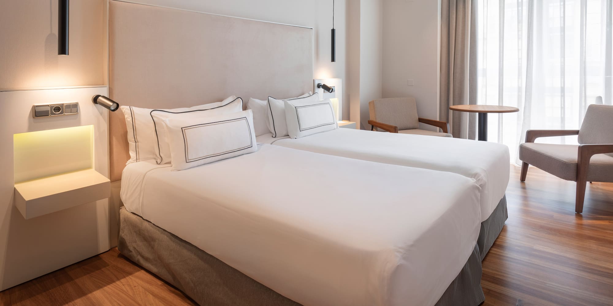 a room with two beds and a table