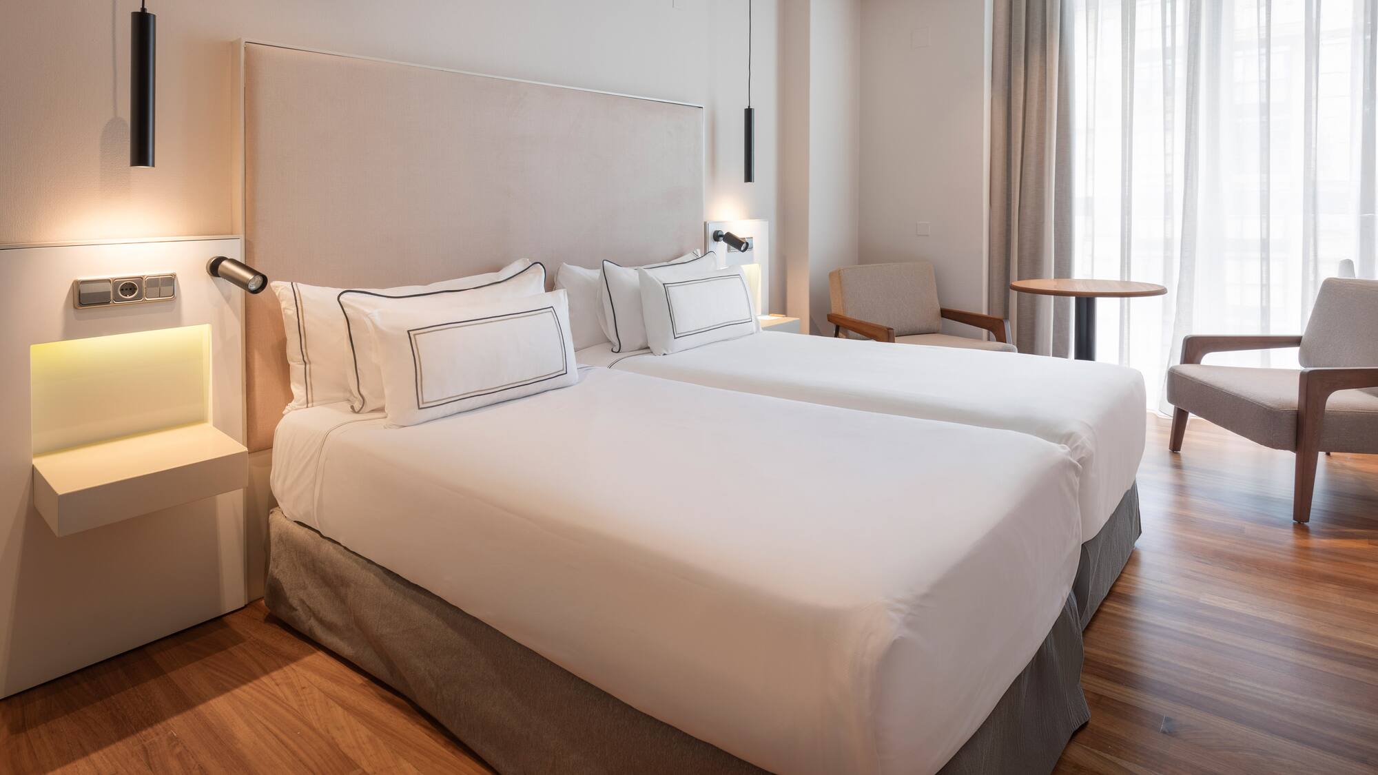 a room with two beds and a table