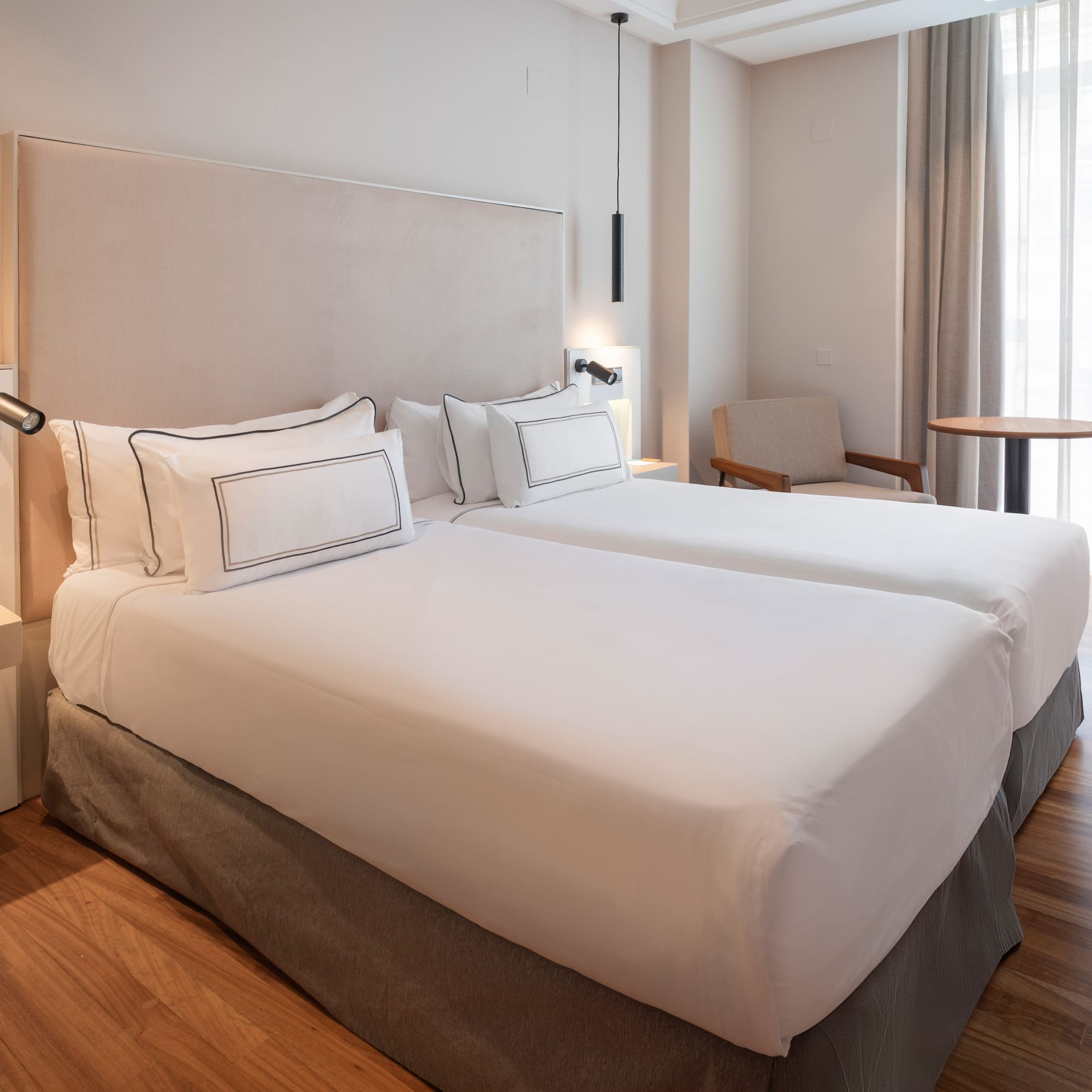 a room with two beds and a table