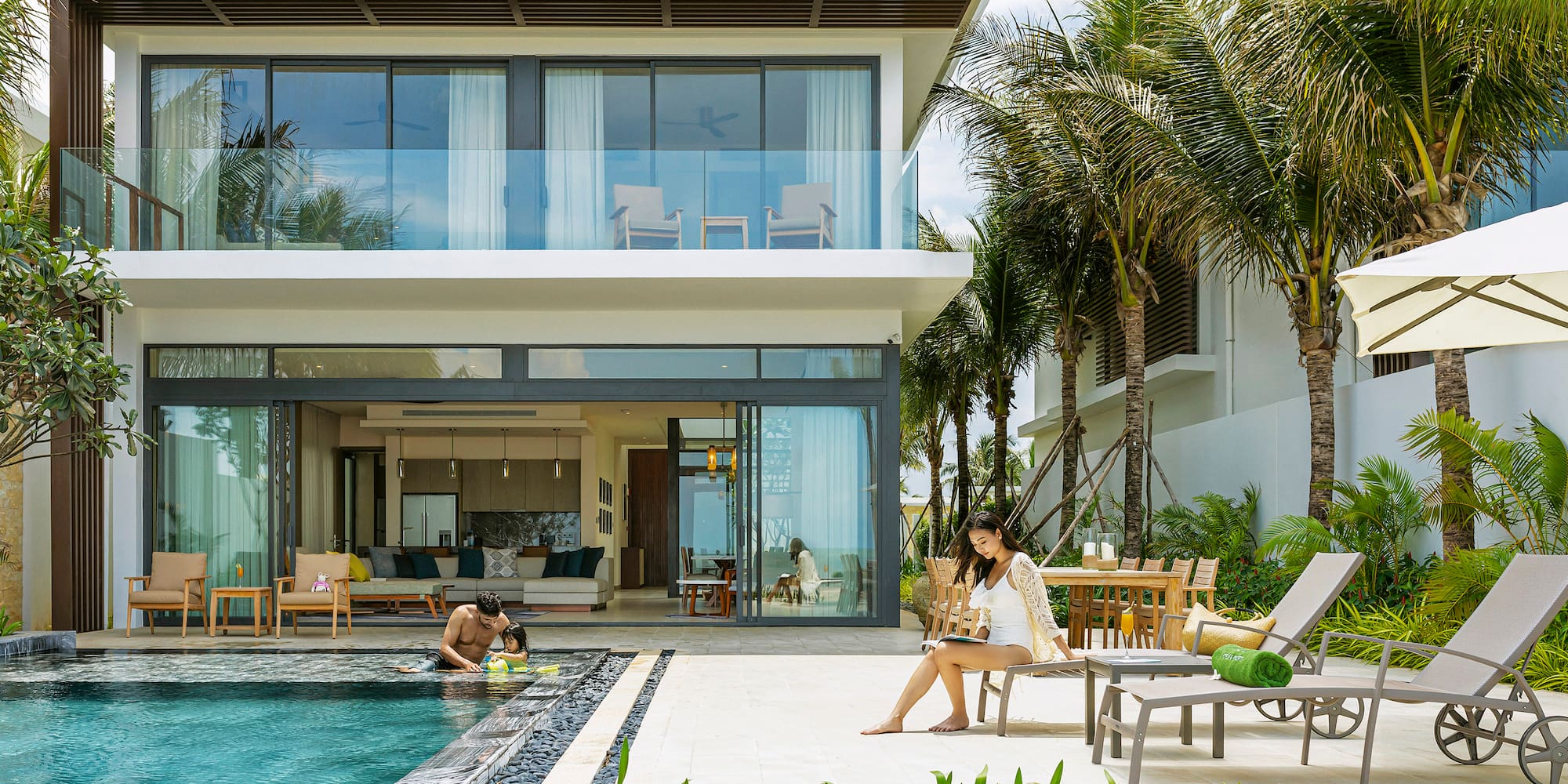 Luxury villa private pool, family relaxing at tropical resort.
