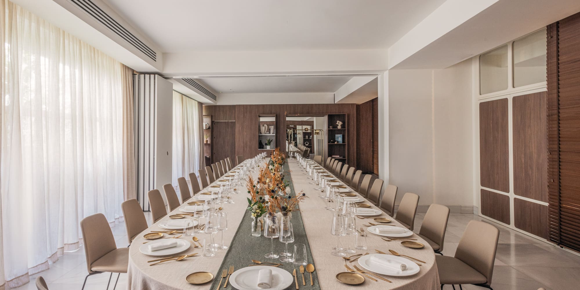 a long table with plates and glasses
