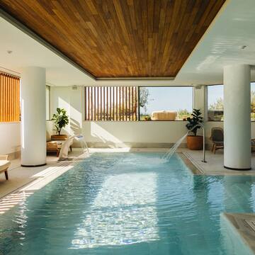 a indoor swimming pool with a waterfall
