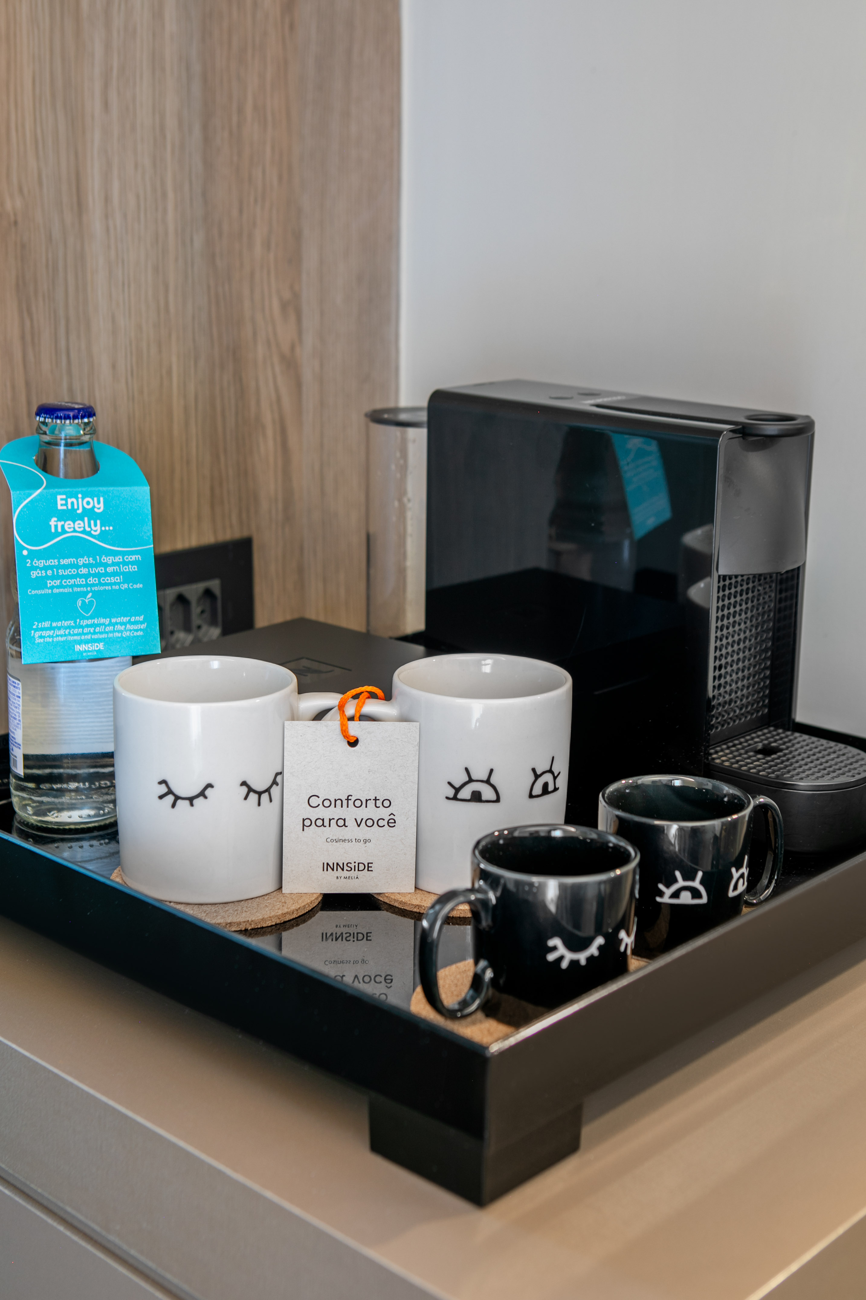 INNSIDE hotel coffee machine & cozy eye-design mugs on amenity tray.