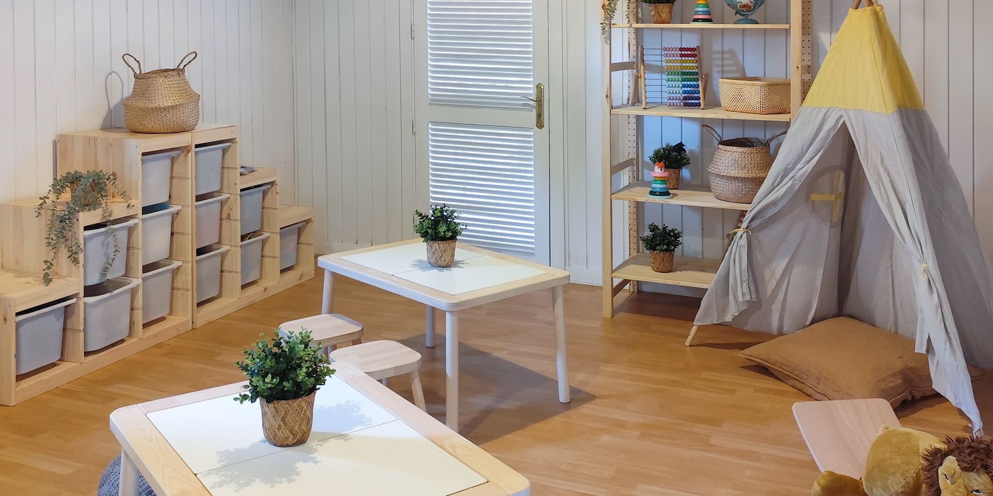 a room with a teepee and tables and chairs