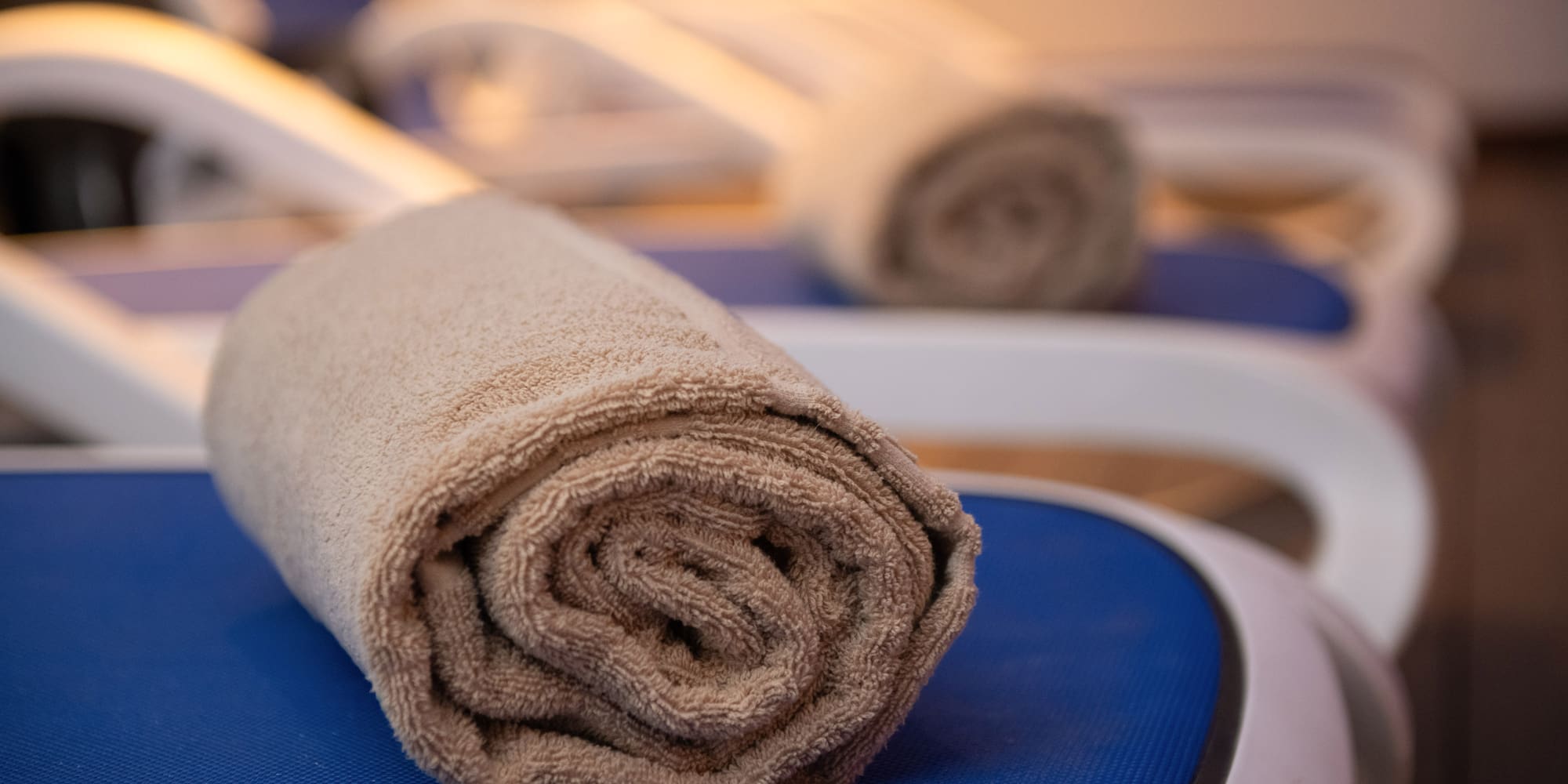 a rolled up towel on a chair