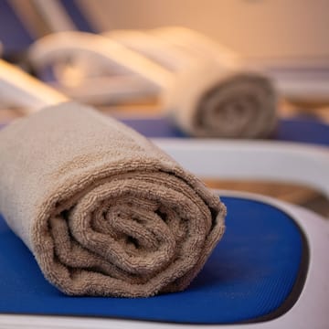 a rolled up towel on a chair