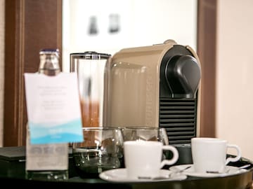a coffee machine and cups on a table
