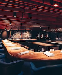 a room with a long table and chairs