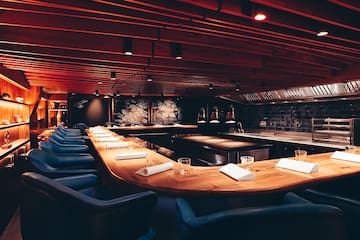 a room with a long table and chairs