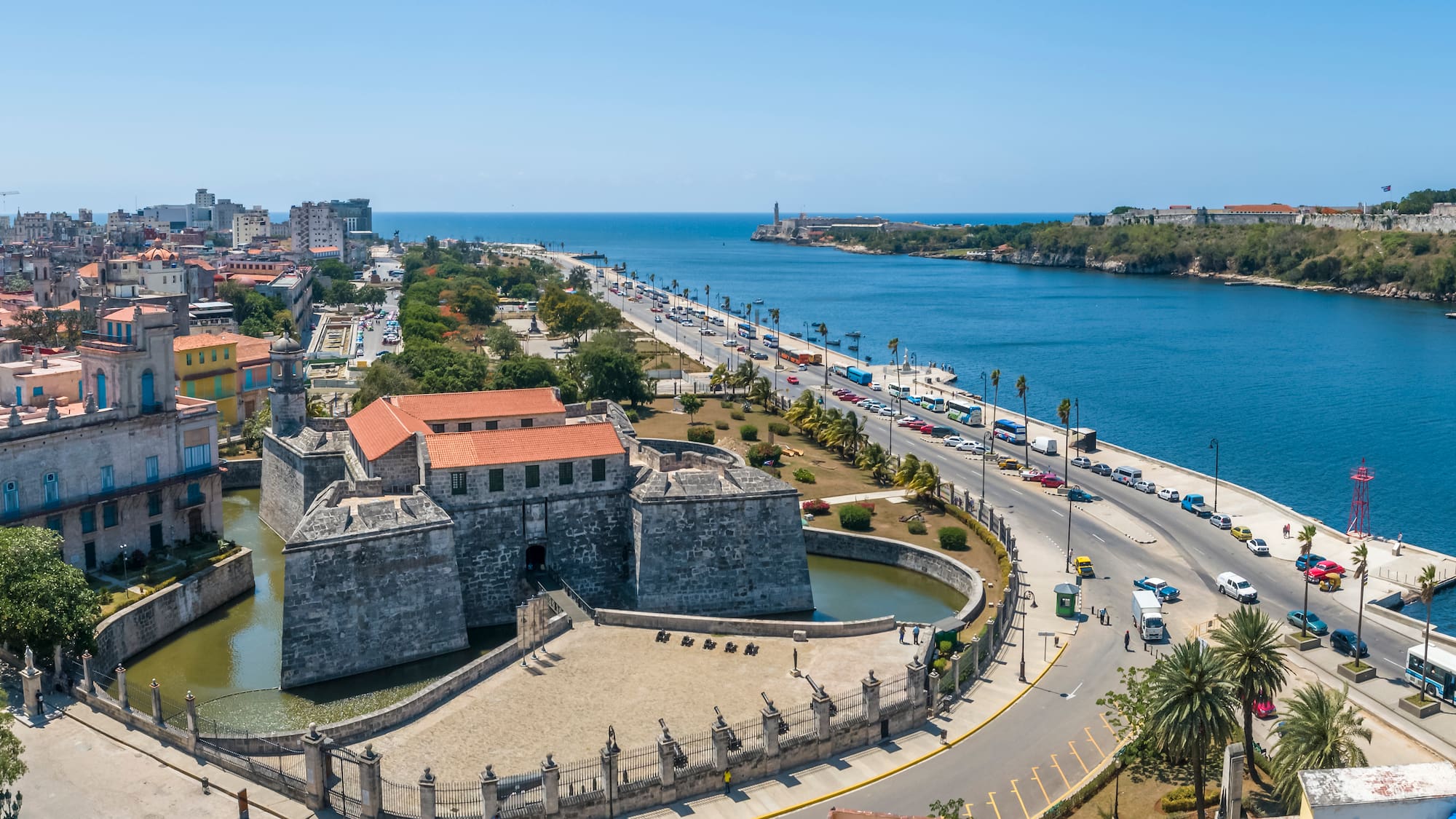 a large stone building next to a body of water