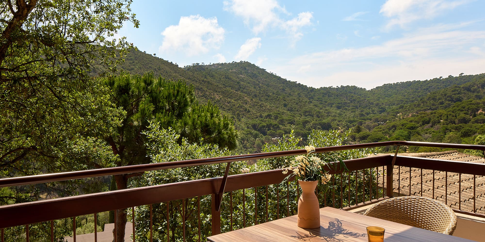 a table with a book and a book on a balcony overlooking a valley