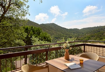 a table with a book and a book on a balcony overlooking a valley