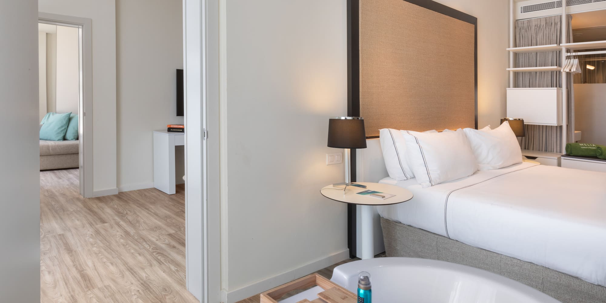 a bedroom with a bathtub and a bed