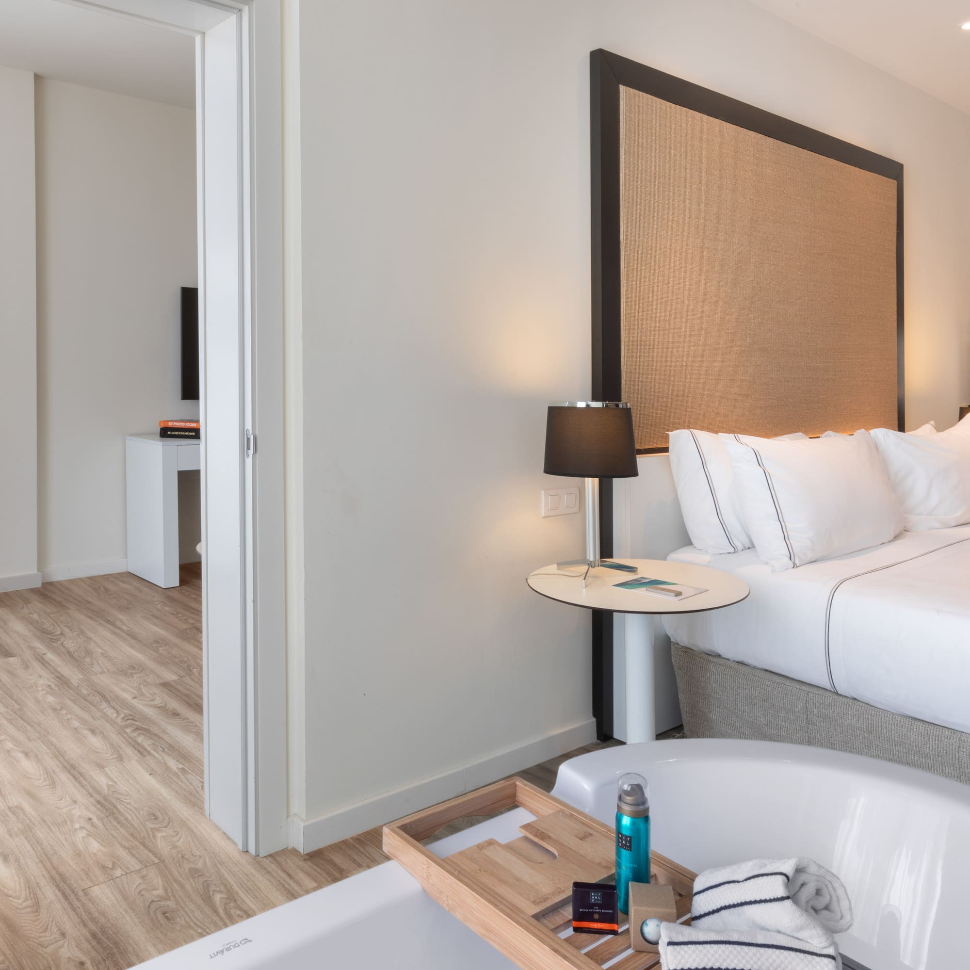 a bedroom with a bathtub and a bed