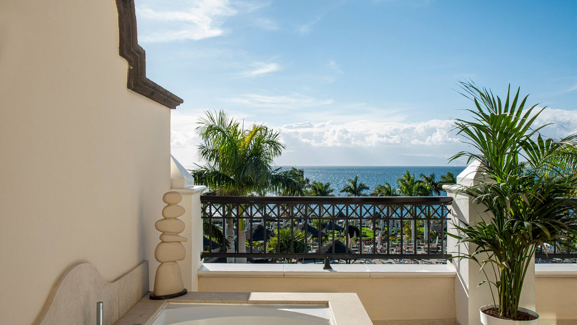 a bathtub on a balcony overlooking the ocean