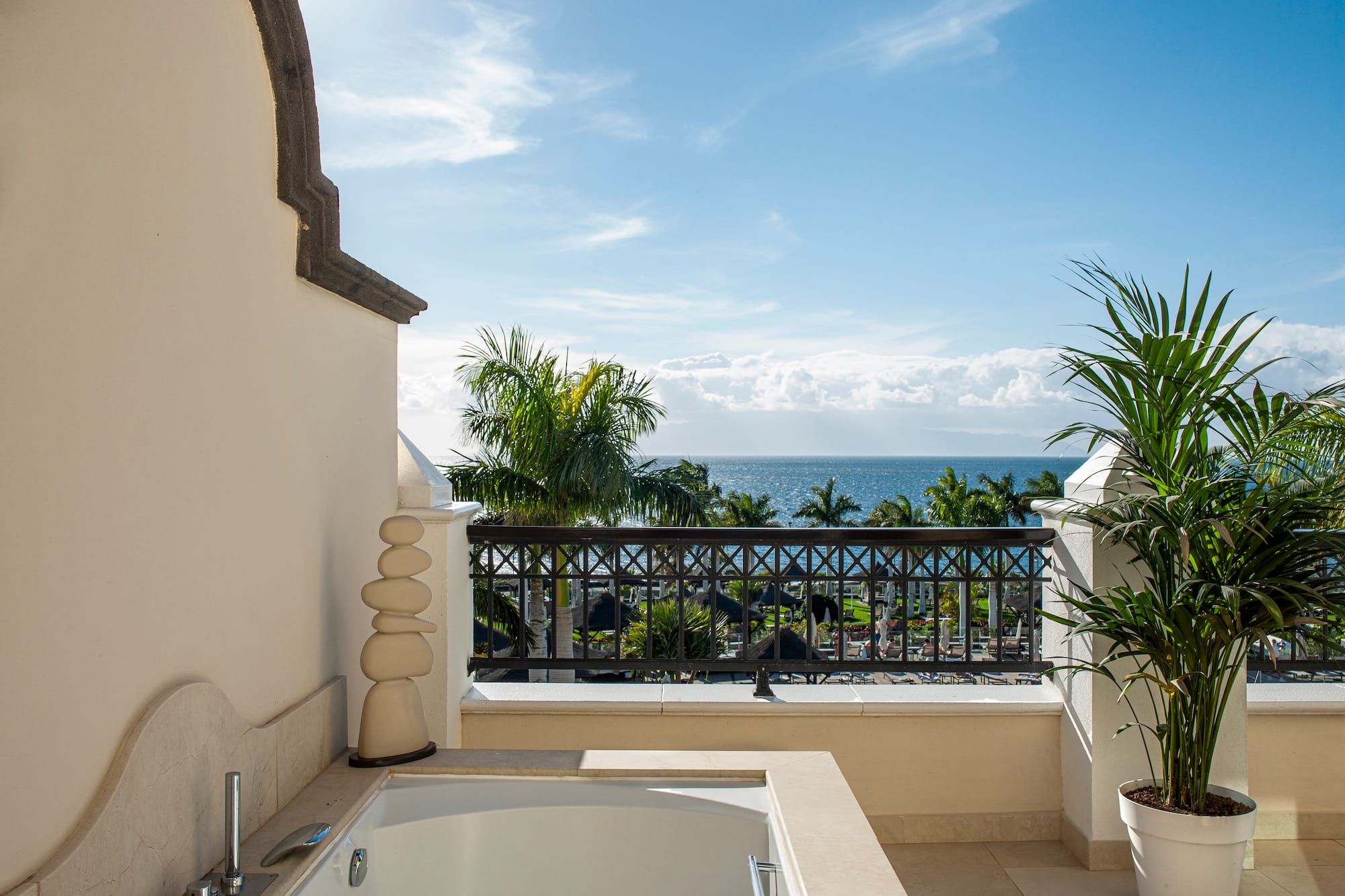 a bathtub on a balcony overlooking the ocean