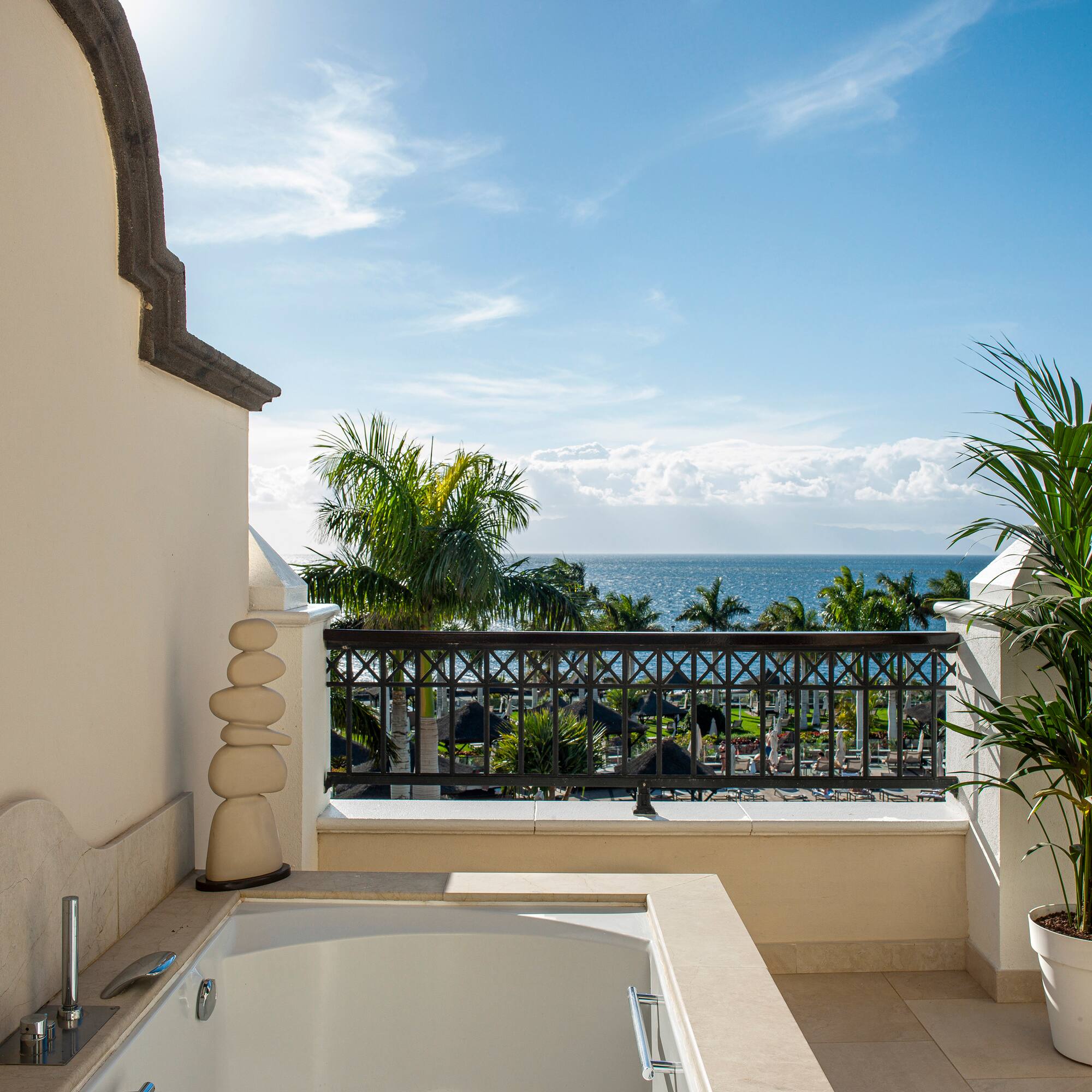 a bathtub on a balcony overlooking the ocean