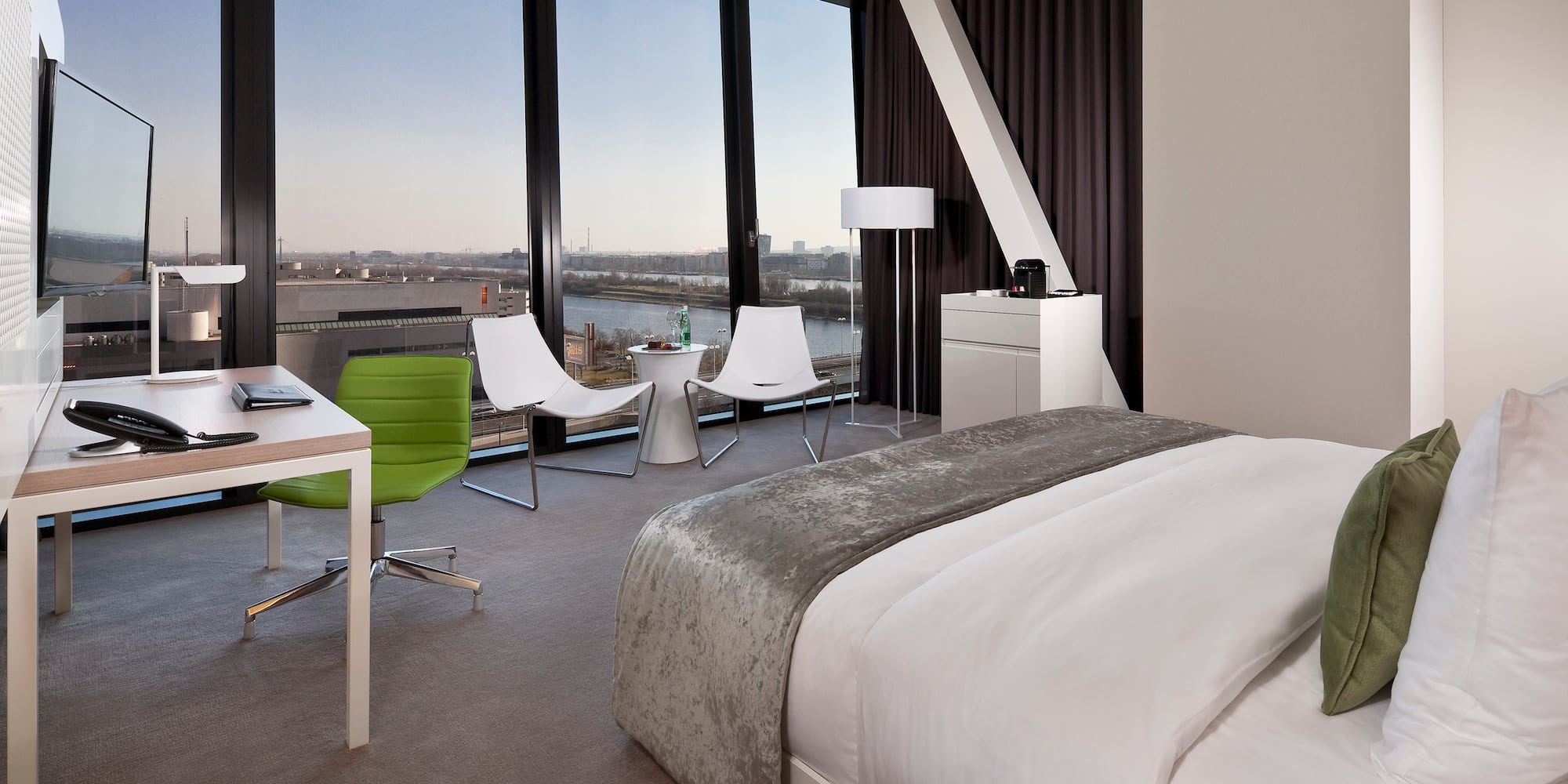 a room with a large window overlooking a city