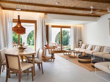 a living room with a table and chairs