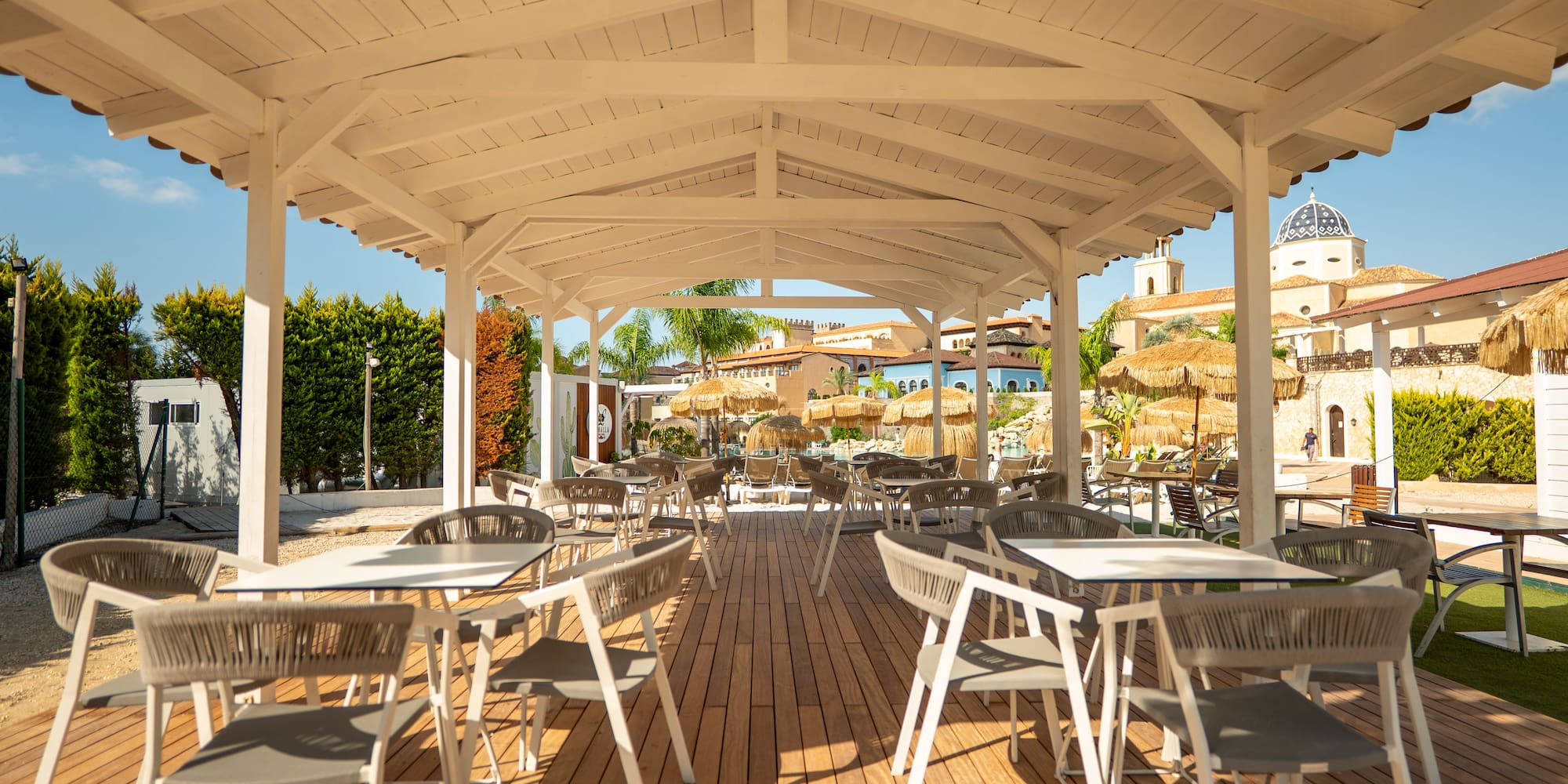 a white covered patio with tables and chairs