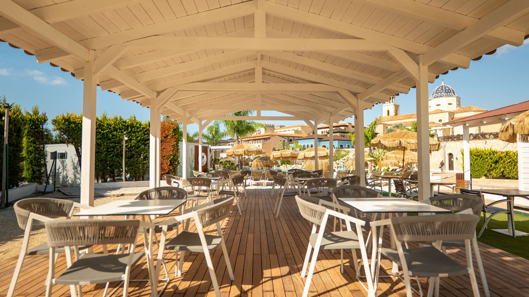 a white covered patio with tables and chairs