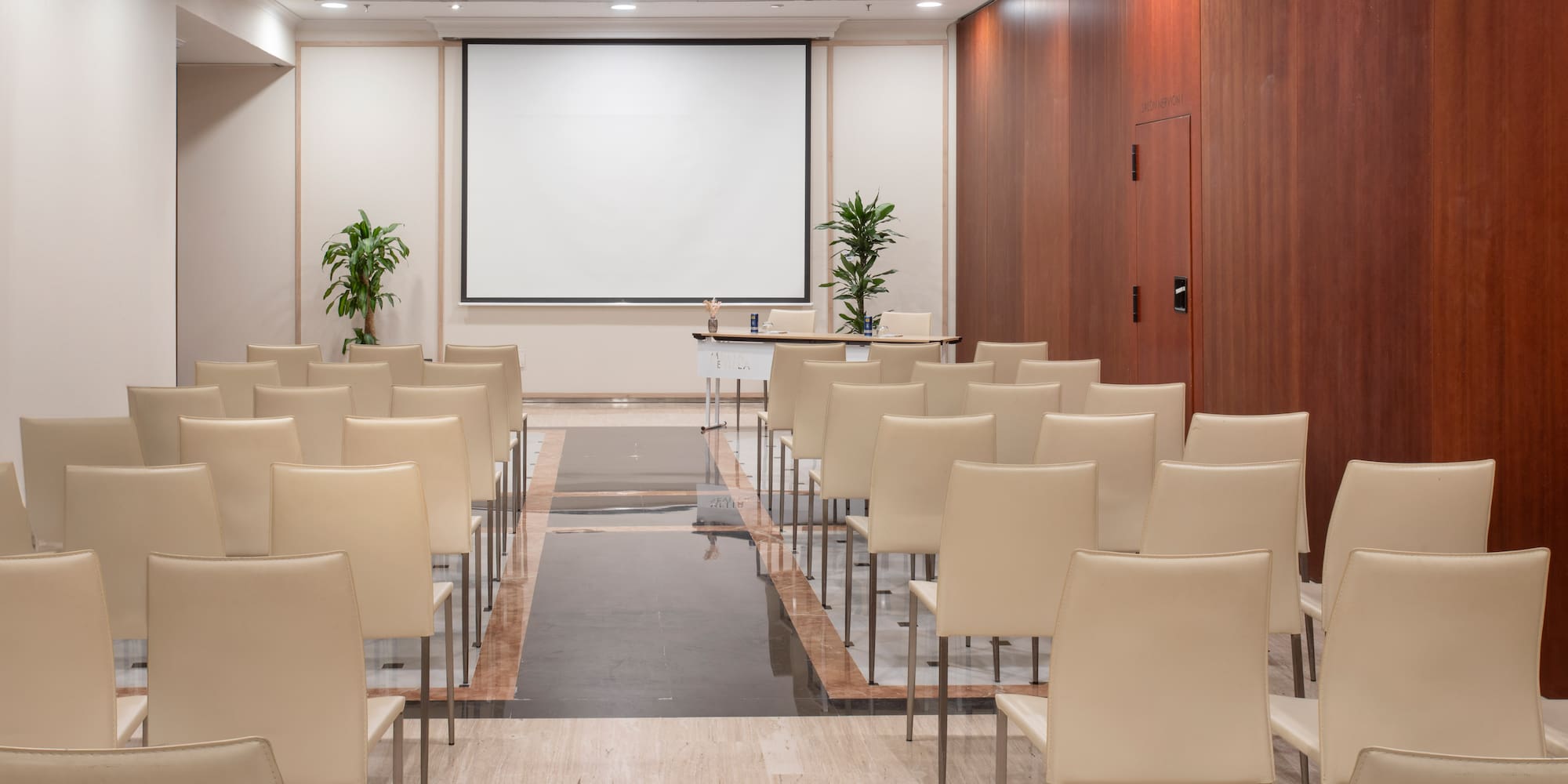 a room with chairs and a projector screen