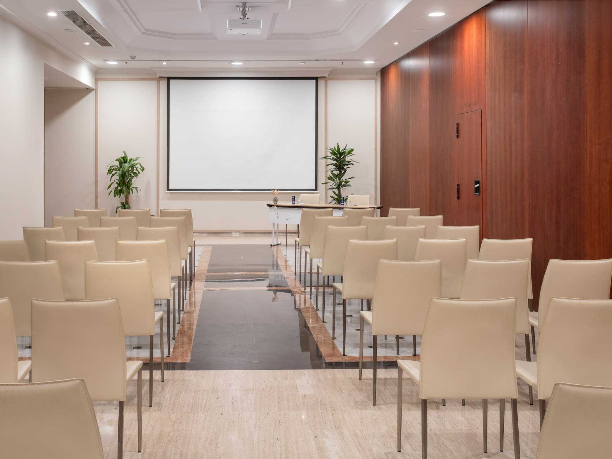 a room with chairs and a projector screen