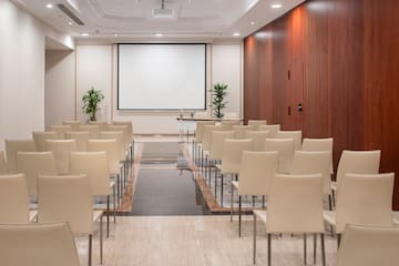 a room with chairs and a projector screen