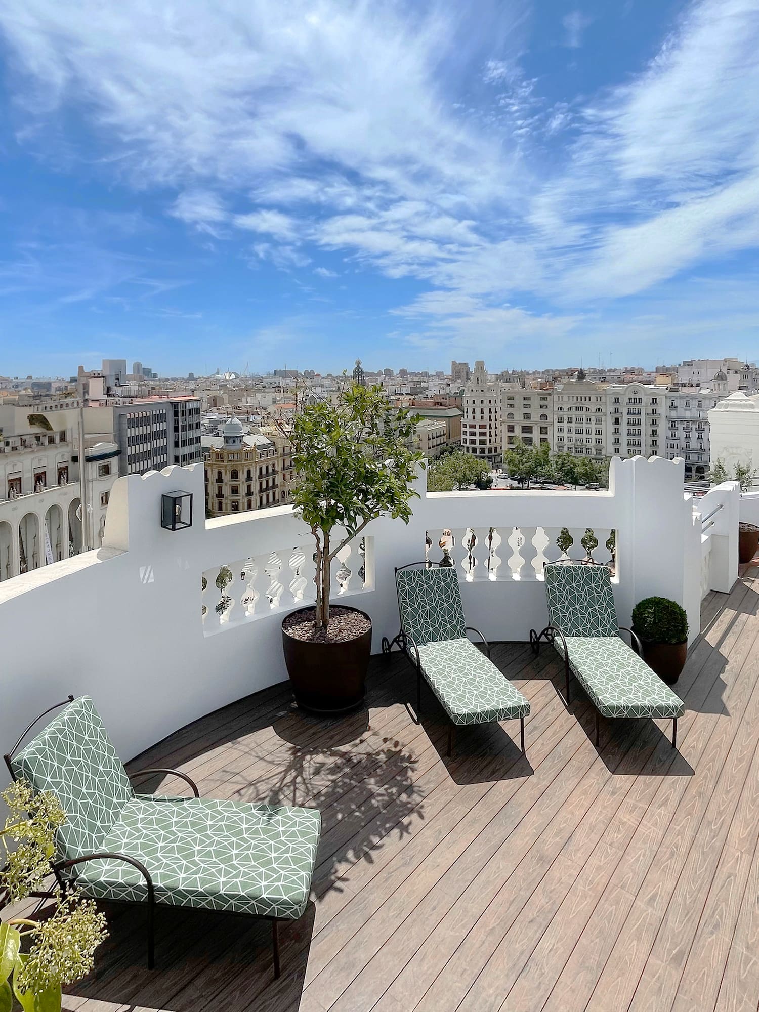 chairs on a deck overlooking a city