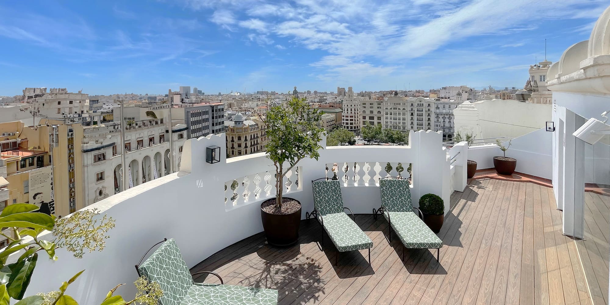chairs on a deck overlooking a city