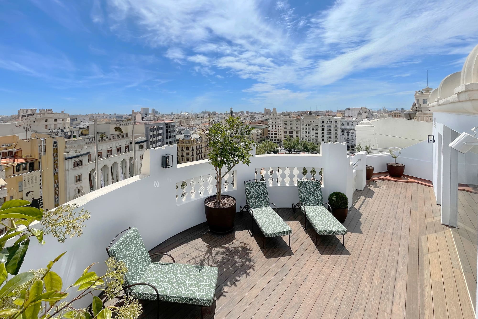 chairs on a deck overlooking a city