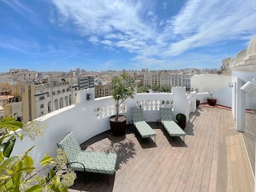 chairs on a deck overlooking a city