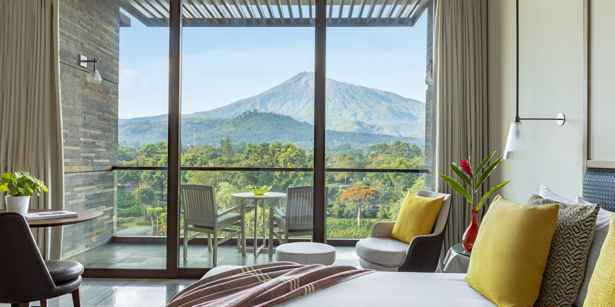 a bedroom with a view of mountains and trees