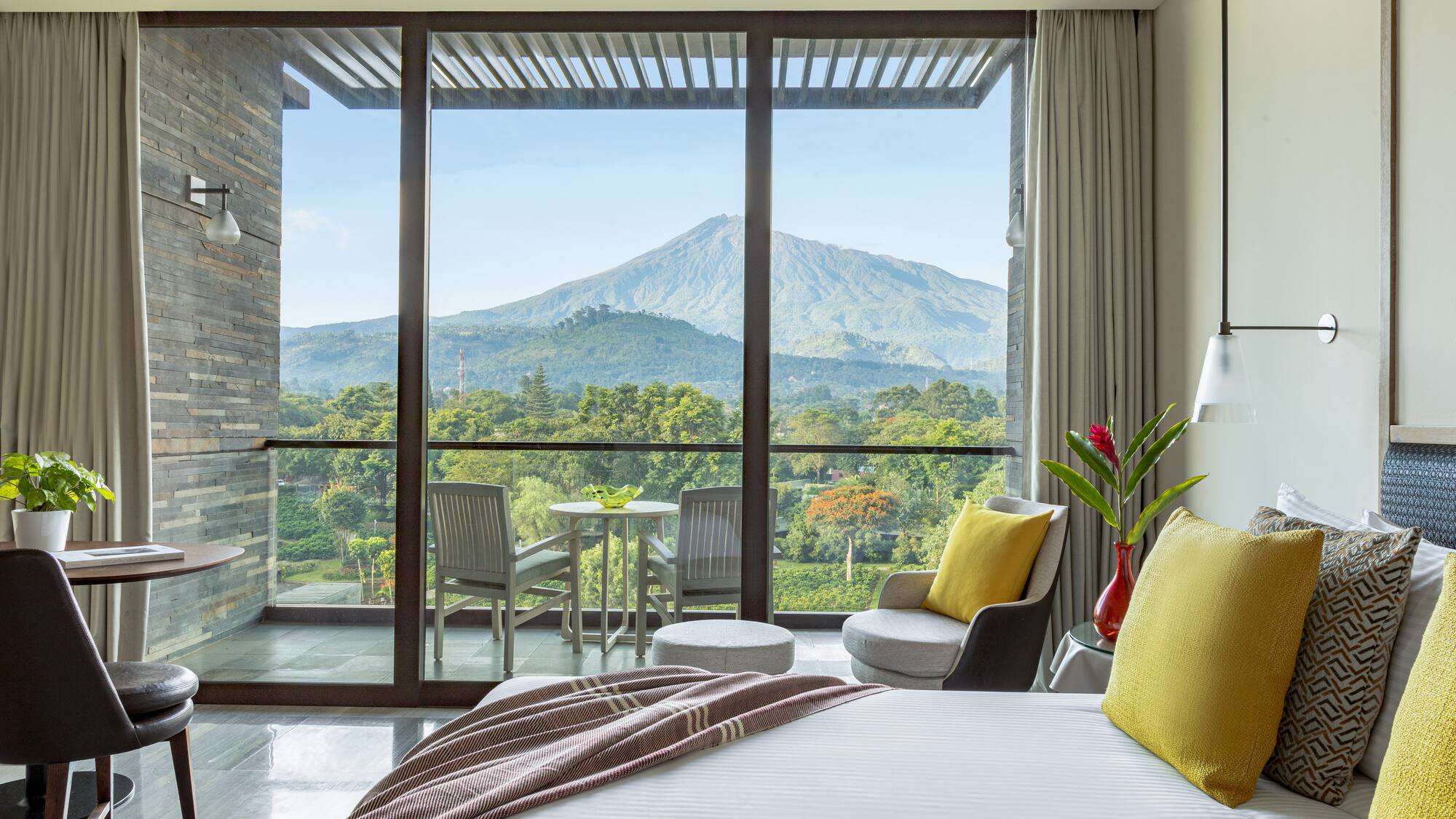 a bedroom with a view of mountains and trees