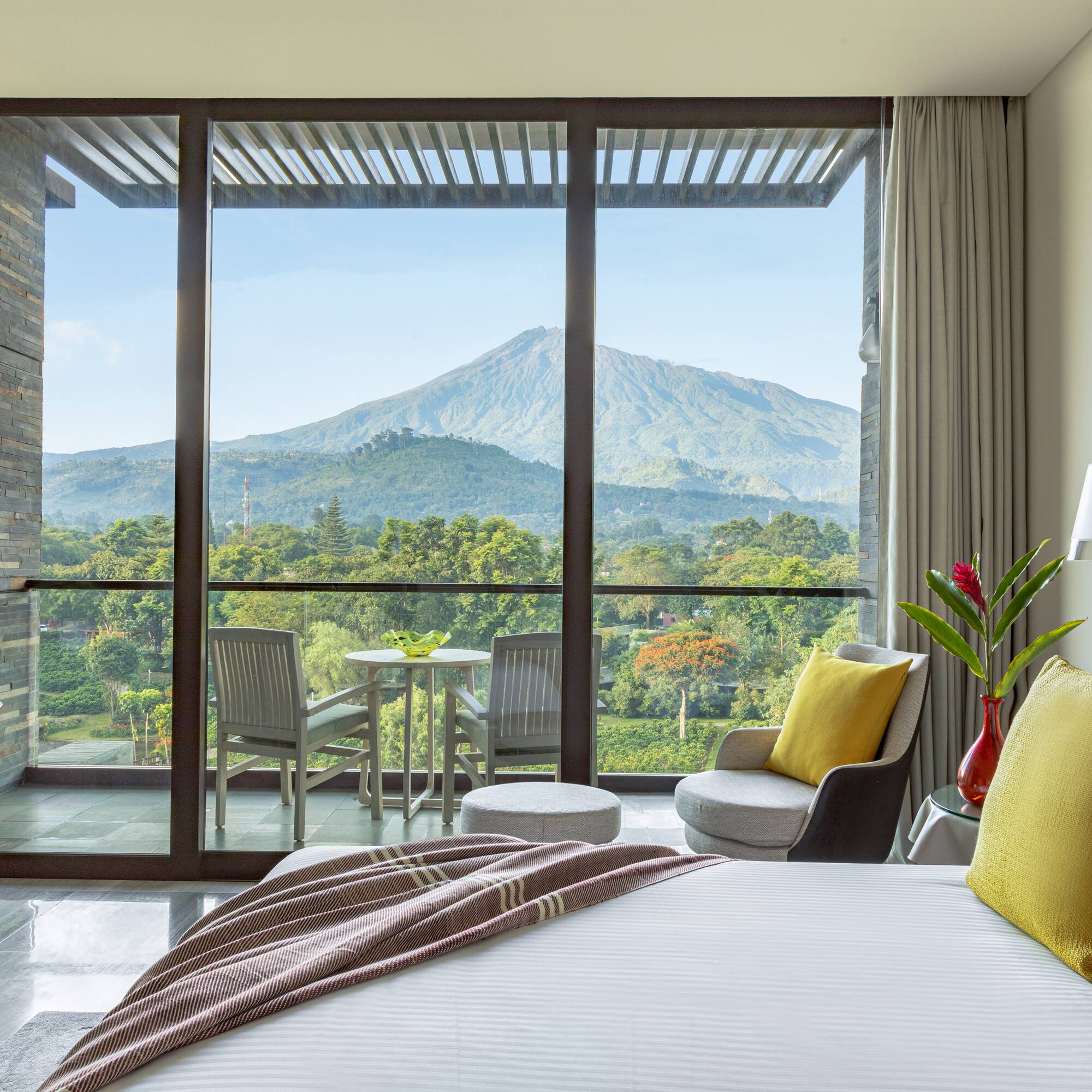 a bedroom with a view of mountains and trees
