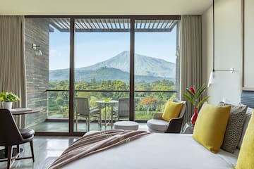 a bedroom with a view of mountains and trees