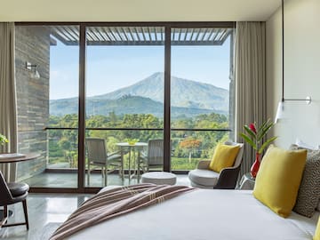 a bedroom with a view of mountains and trees