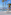 Luxury resort infinity pool with ocean view, palm trees, and sun loungers.