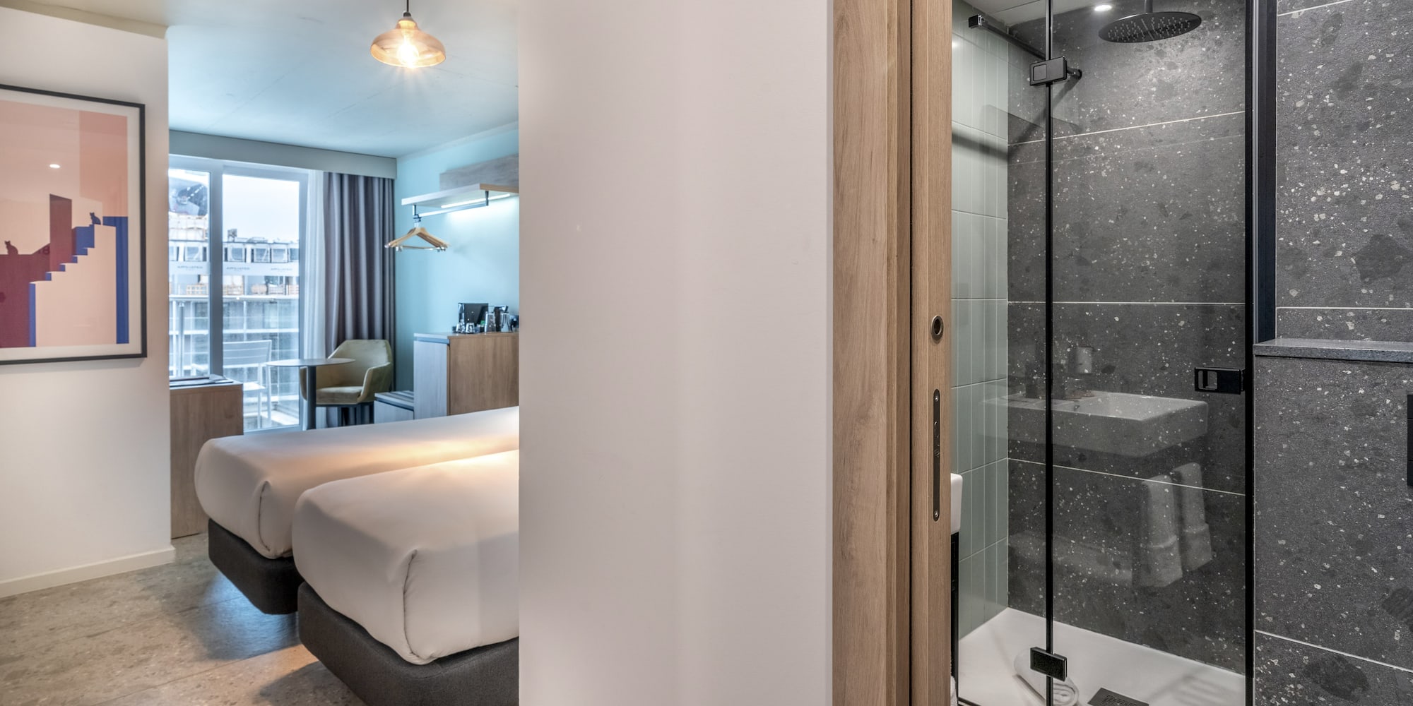 a room with two beds and a shower