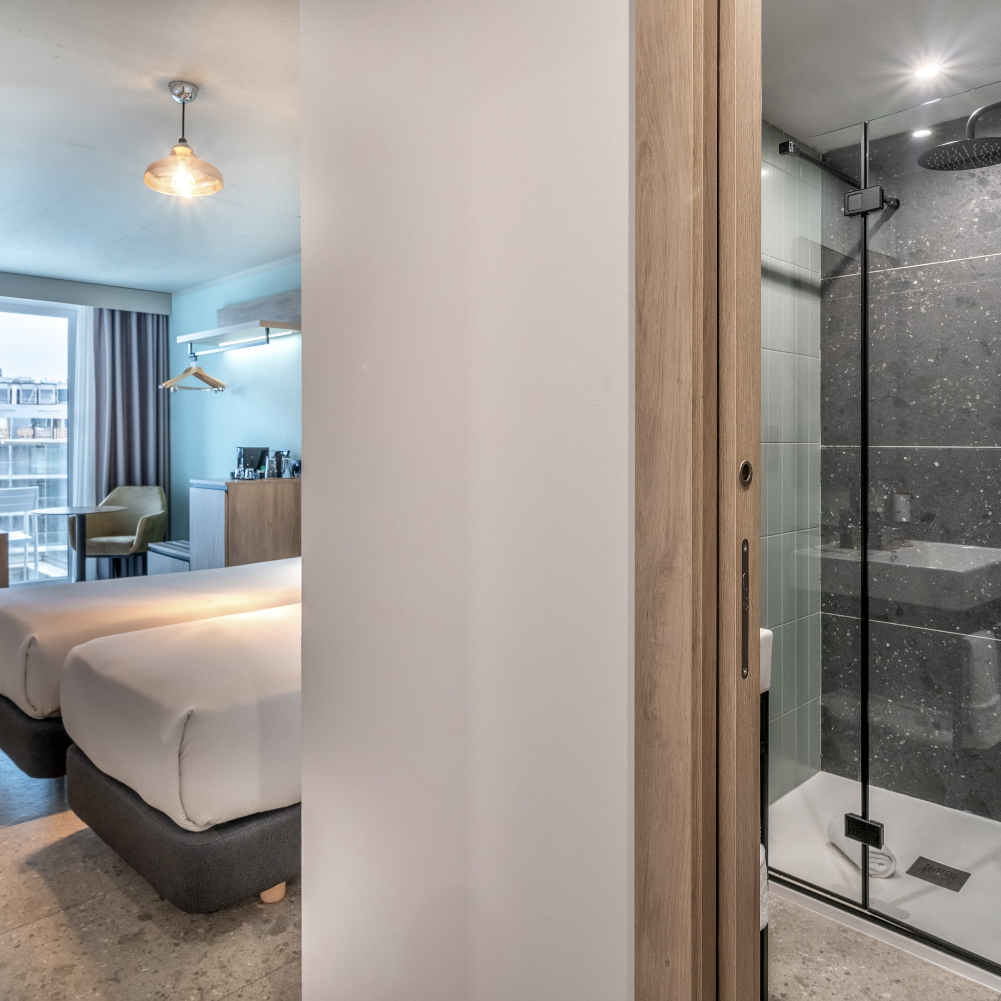 a room with two beds and a shower