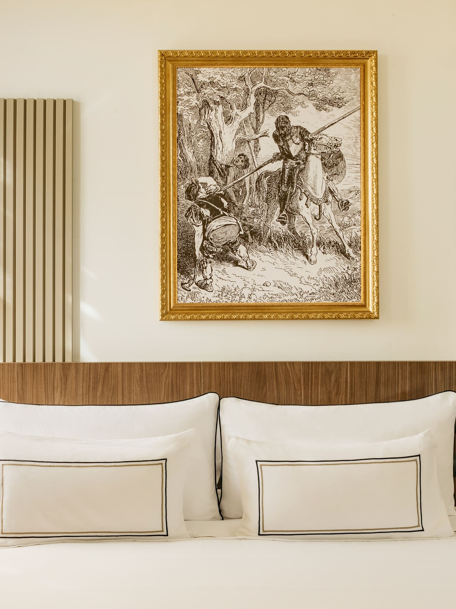 a bed with a gold frame on the wall