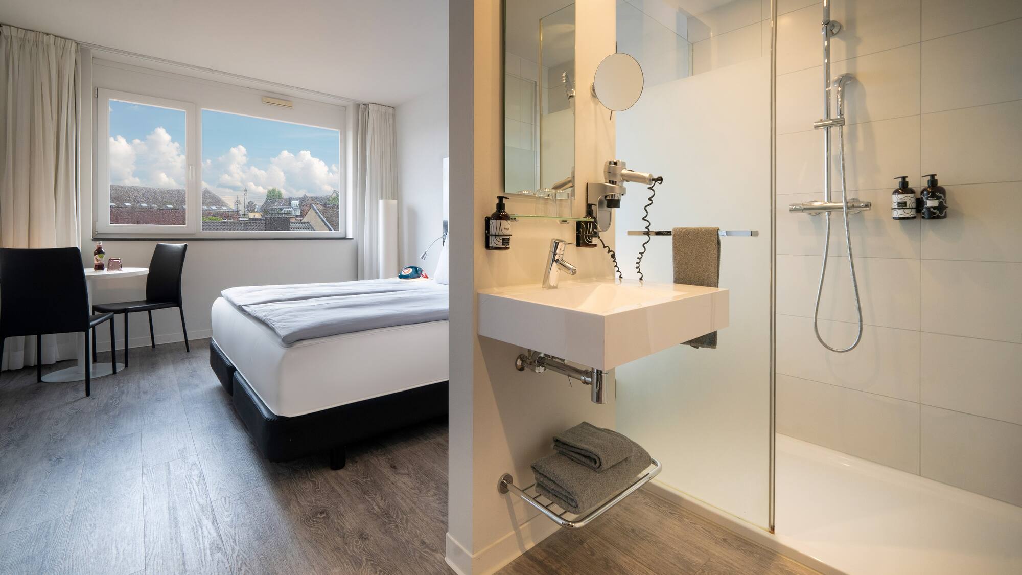 a bathroom with a shower and a bed