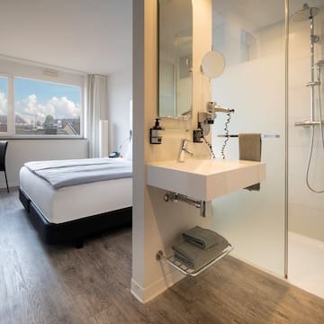 a bathroom with a shower and a bed