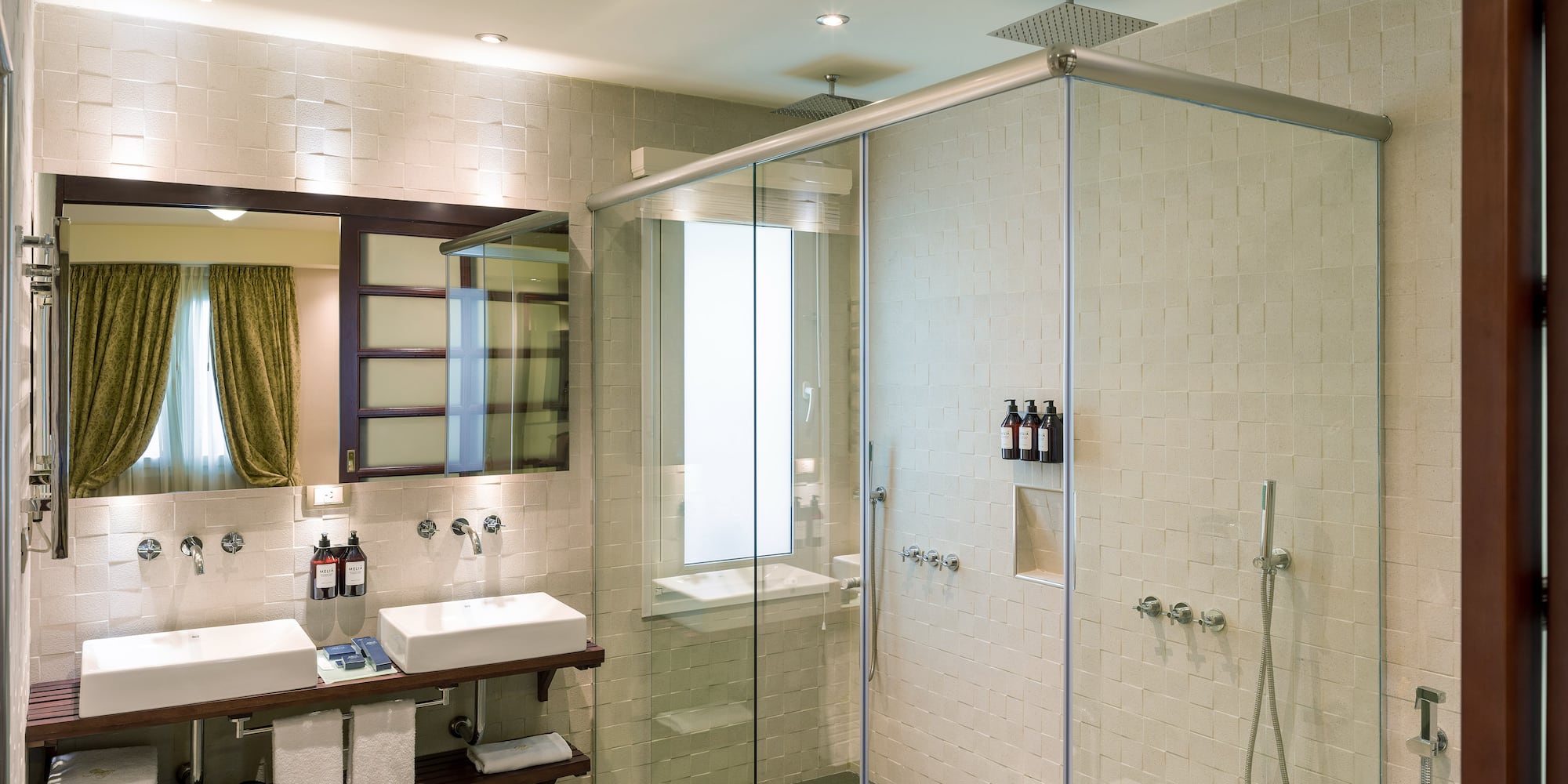a bathroom with a glass shower and sink