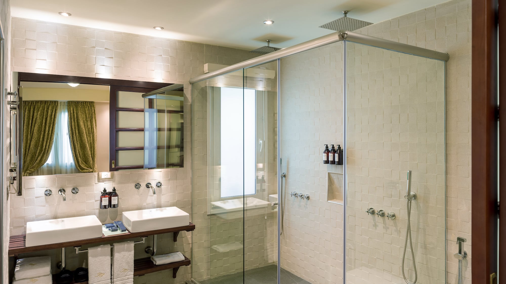 a bathroom with a glass shower and sink