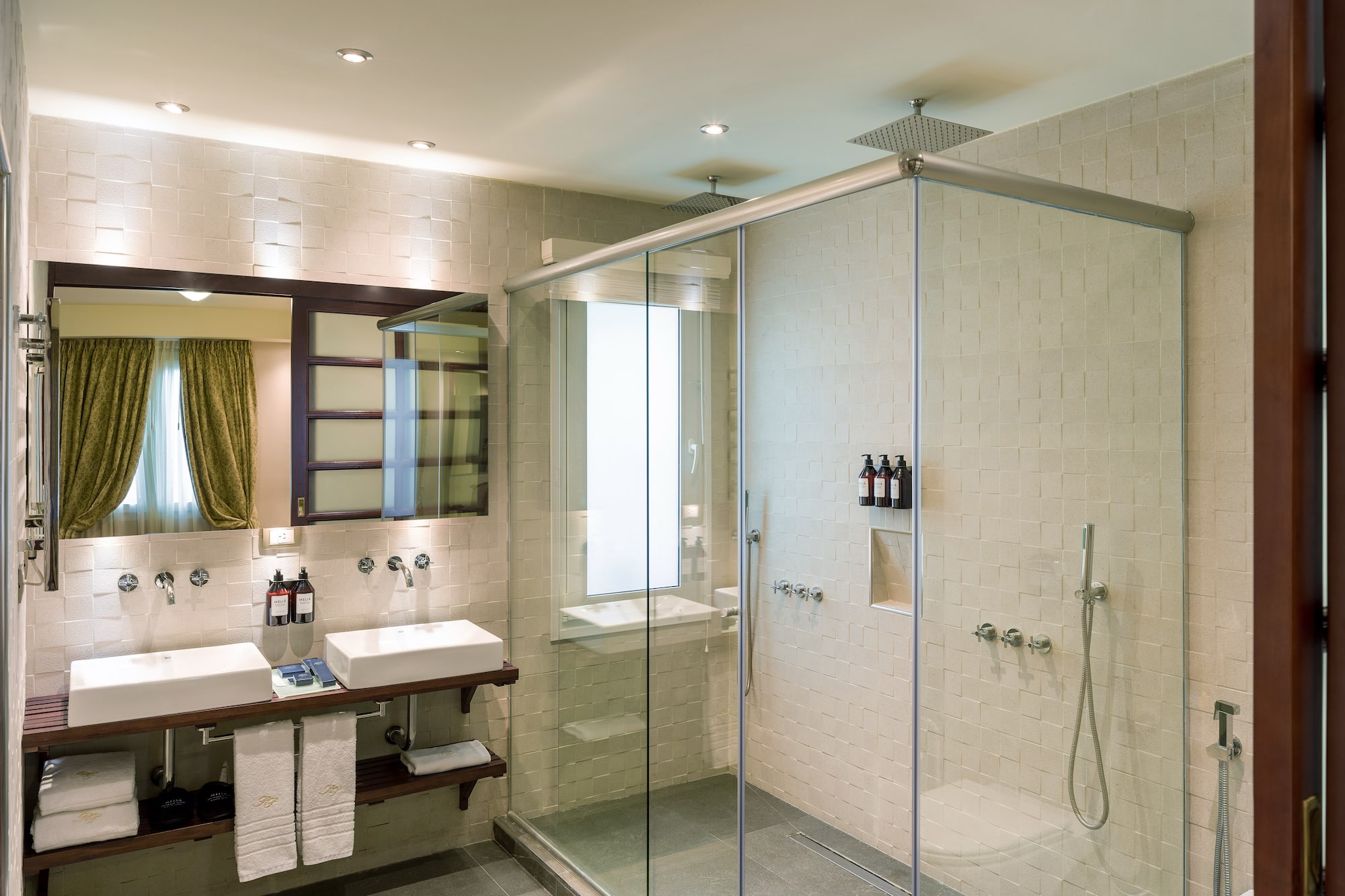 a bathroom with a glass shower and sink