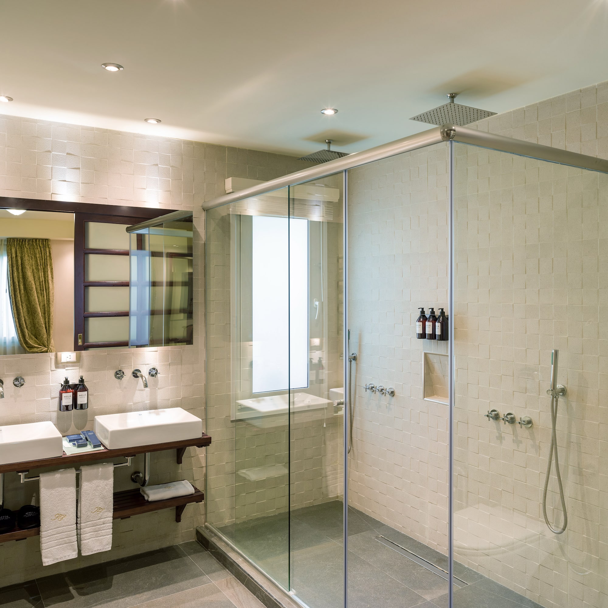 a bathroom with a glass shower and sink